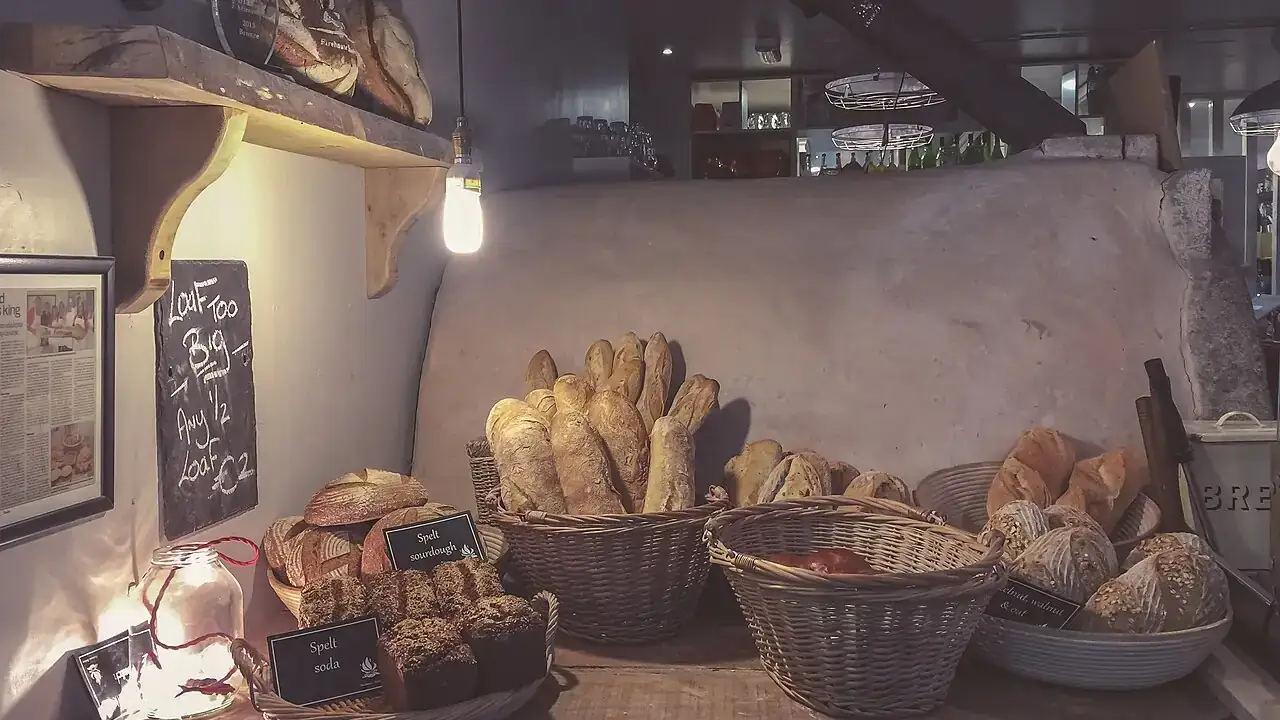 Rustic loaves in baskets on a bakery shelf